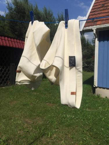 two white towels hanging on a clothes line at Błękitny Domek - Tleń - Bory Tucholskie in Tleń