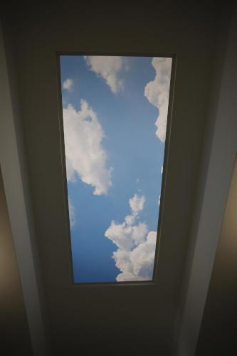 a window in the ceiling of a room with a sky at Casa da Praça in Ponte de Sor