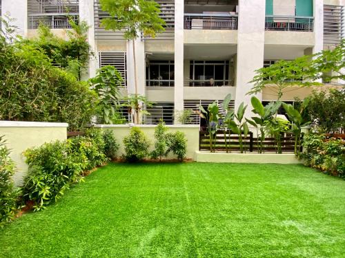 a green lawn in front of a building at BNB Cozy Homestay @ Cyberjaya in Cyberjaya