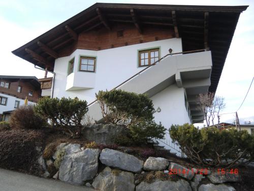 a house with a staircase in front of it at Apartment Daxauer in Sankt Johann in Tirol
