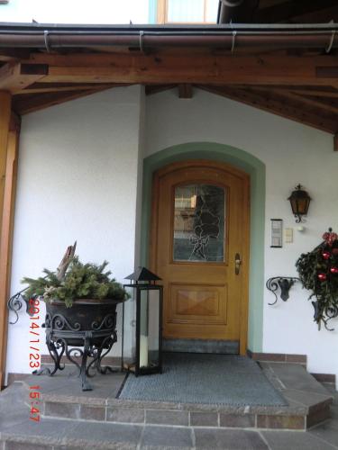 a front door of a house with a bench at Apartment Daxauer in Sankt Johann in Tirol