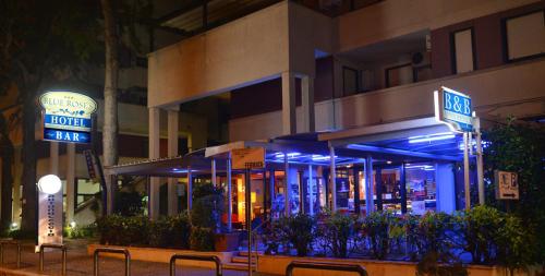 a building with blue lights in front of it at Hotel Blue Rose's in Mesagne