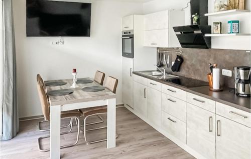 a kitchen with a table and chairs in a room at Lovely Apartment In Graal-Müritz in Graal-Müritz