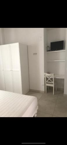 a bedroom with a bed and a table and a chair at Camere Maré in Sirolo