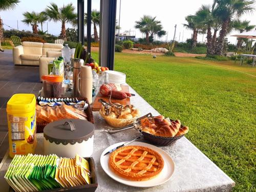 a picnic table with waffles and other food on it at B&B Brezza Delle Egadi in Marsala