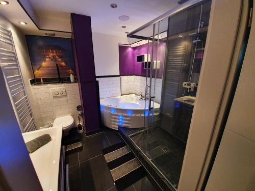 ein Badezimmer mit einer Badewanne, einem WC und einem Waschbecken in der Unterkunft SinueSsa in Köln