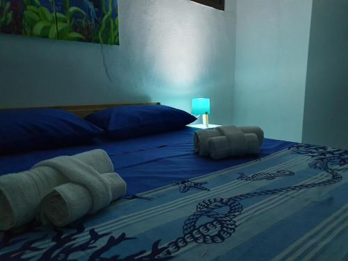 a bed with blue sheets and towels on it at Alle Porte del Capo in Palermo