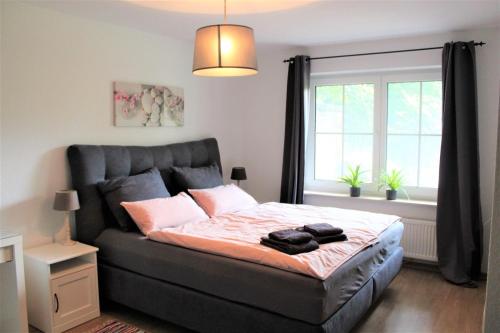 a bedroom with a large bed with a window at FeWo an der Mühle in Bad Bentheim