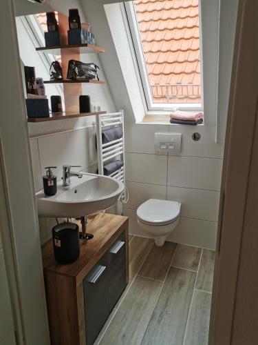 a bathroom with a sink and a toilet at Gästeoase einfach wohl fühlen in Wolfhagen