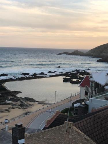 a view of the ocean with a house and a road at Apartment Ozone in Herolds Bay