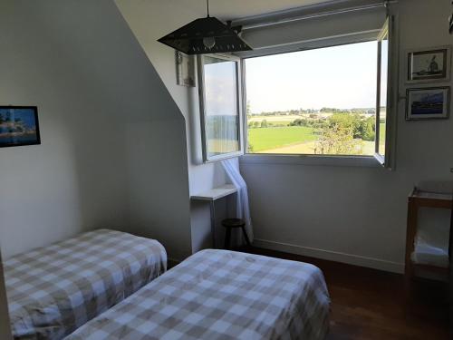 Cette chambre comprend deux lits et une grande fenêtre. dans l'établissement L'étoile CarVal, à Sains