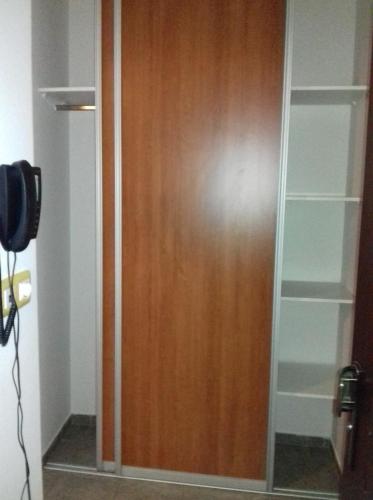 a closet with a wooden door in a room at Apartment Nice View in Fojnica