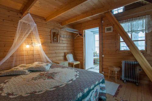 1 dormitorio con 1 cama en una cabaña de madera en Västriku Holiday Home, en Nasva