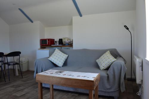 a living room with a couch and a coffee table at Plain Street Cottage, The Barn B&B in Port Isaac