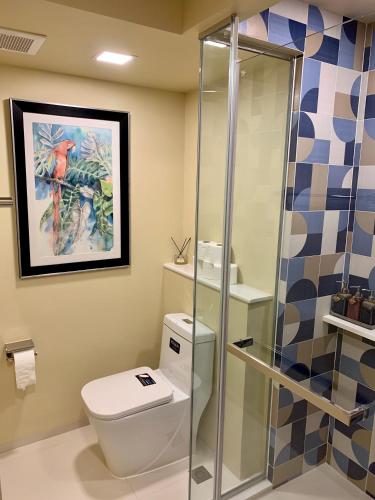 a bathroom with a toilet and a shower at New Cosy Apartment at Marvest Huahin City Center in Hua Hin