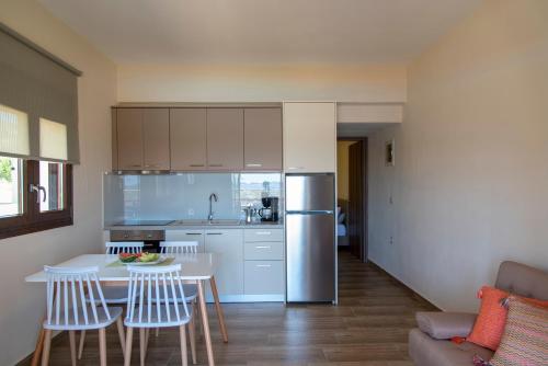 a kitchen with a table and chairs and a refrigerator at ONAR in Palekastron