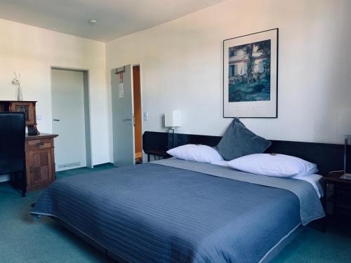 Hotel Mainzer Hof tesisinde bir odada yatak veya yataklar