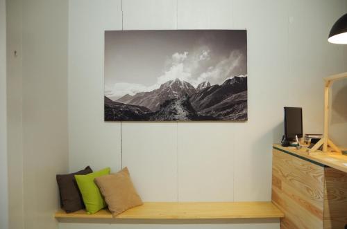 a picture of a mountain hanging on a wall at Travelers' house ROOTs in Takaoka