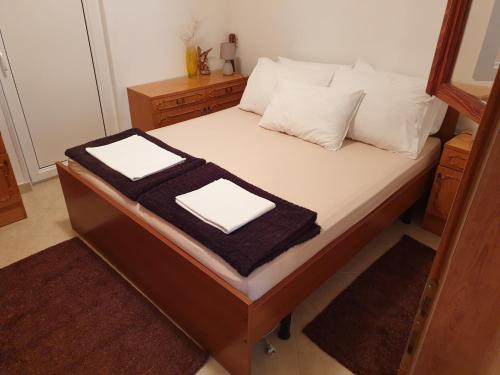 a bed with two towels on top of it at Ana in Kostrena