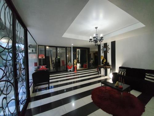 a living room with a black and white striped floor at @Room Apartment in Bangkok
