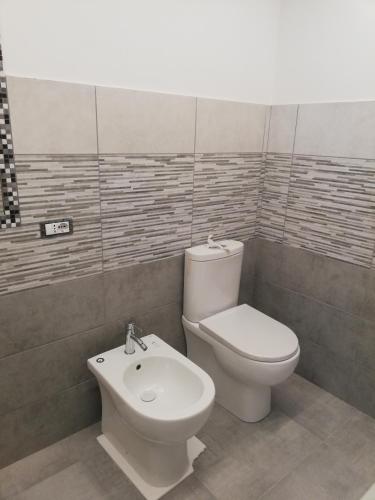 a bathroom with a toilet and a bidet at Sapore di Sale - Sicily Rooms in Siracusa