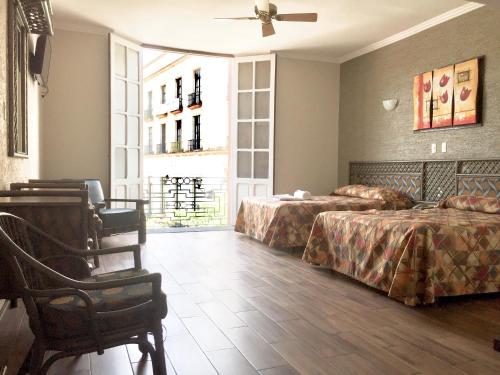 a hotel room with two beds and a window at Hotel Mexico in Xalapa