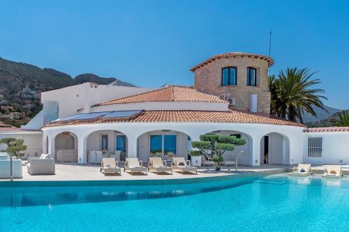 a villa with a swimming pool and a house at Maryvilla Inspiracion y Vacaciones - Grand Villa Penon in Calpe