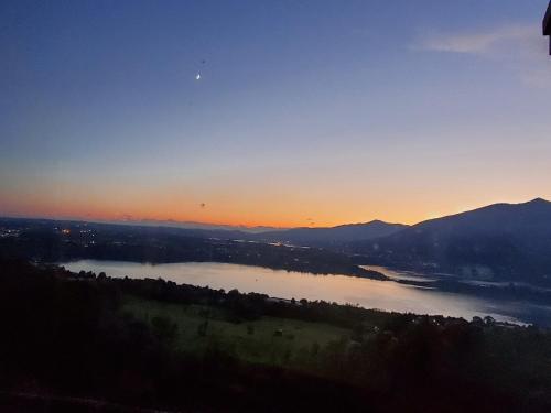 a view of a lake at sunset at Antica Locanda La Tinara del Belvedere - Romantic Dreams - in Galbiate
