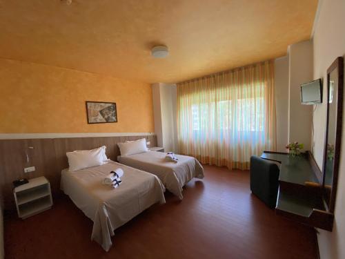 Voodi või voodid majutusasutuse Park Hotel Bozzi toas