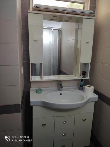 a bathroom with a sink and a mirror at Brb rooms in Himare