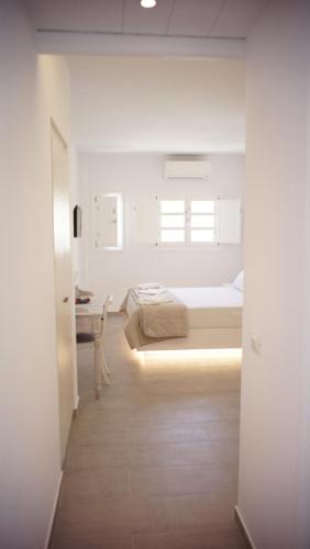 
a room with a white bed and white walls at Paraporti in Chora Folegandros
