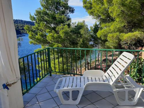 a balcony with two white chairs and a view of the water at Apartment Nono Ivo in Vis