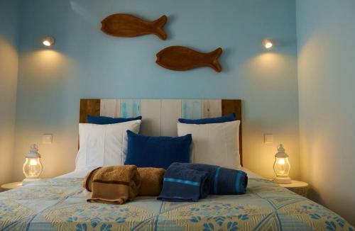 a bed with two pillows on top of it at Velha 34 in Albufeira