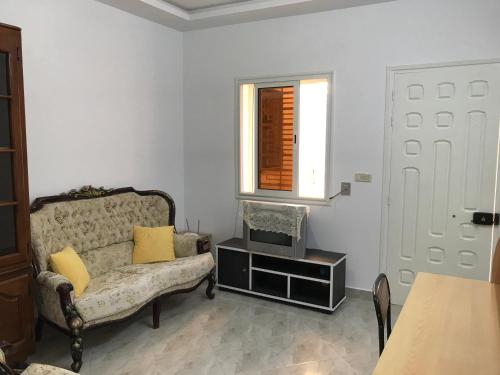 a living room with a couch and a window at Maison de Vacances Tazarka in Tazarka