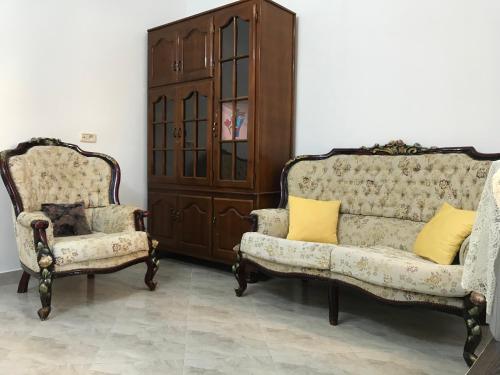 a living room with two chairs and a couch at Maison de Vacances Tazarka in Tazarka