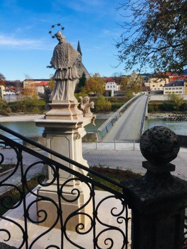 a statue of an angel standing on a bridge at Ferienwohnung an der romantischen Salzachschleife Nähe Salzburg in Laufen