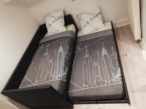 two beds in a box with drawings on them at Appartement refait à neuf à Annecy in Annecy