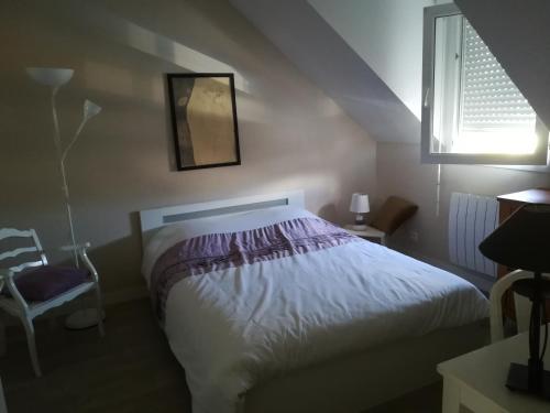 a bedroom with a bed and a window at maison de vacances baie du Mont Saint Michel in Dol-de-Bretagne