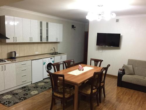 a kitchen and a dining room with a table and chairs at Apartment on Getapnya 74 in Dilijan