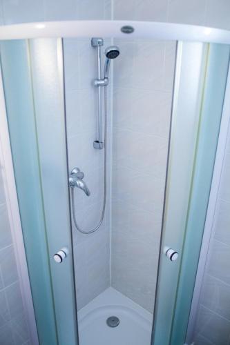 a bathroom with a shower with a glass door at Vila Adria in Hrabušice