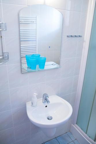 a bathroom with a white sink and a mirror at Vila Adria in Hrabušice