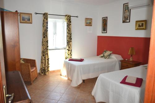 a room with two beds and a window at Monte O Alentejo in Ourique