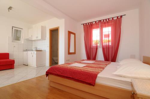 ein Schlafzimmer mit einem großen Bett mit roten Vorhängen in der Unterkunft Villa Zvonko in Makarska