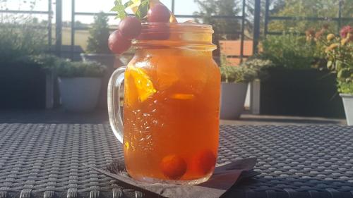 a mason jar filled with orange juice on a table at u Ďurkových in Žabokreky nad Nitrou
