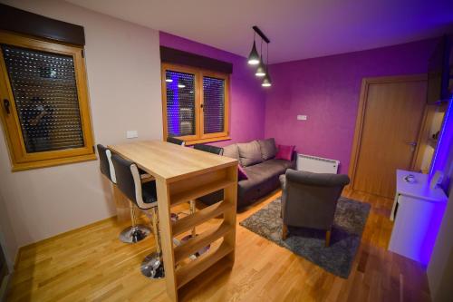a living room with a table and a couch at AMETIST10 in Zlatibor