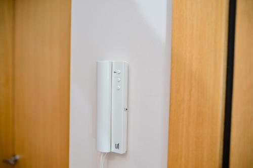 a white switch on a wall next to a door at AMETIST10 in Zlatibor