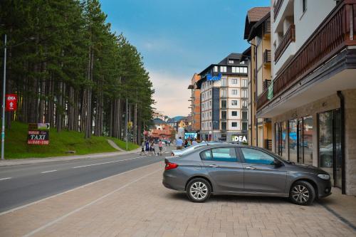 a silver car parked on the side of a street at AMETIST10 in Zlatibor