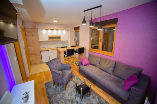 a living room with a couch and a kitchen at AMETIST10 in Zlatibor