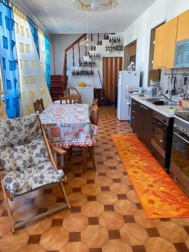 a kitchen with a table and chairs and a kitchen with a kitchen at nena in Diso
