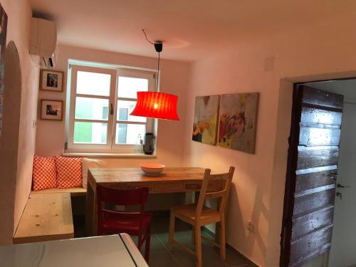 a dining room with a table and chairs and a window at VILLA IL BLU direkt am Meer in Martinšćica